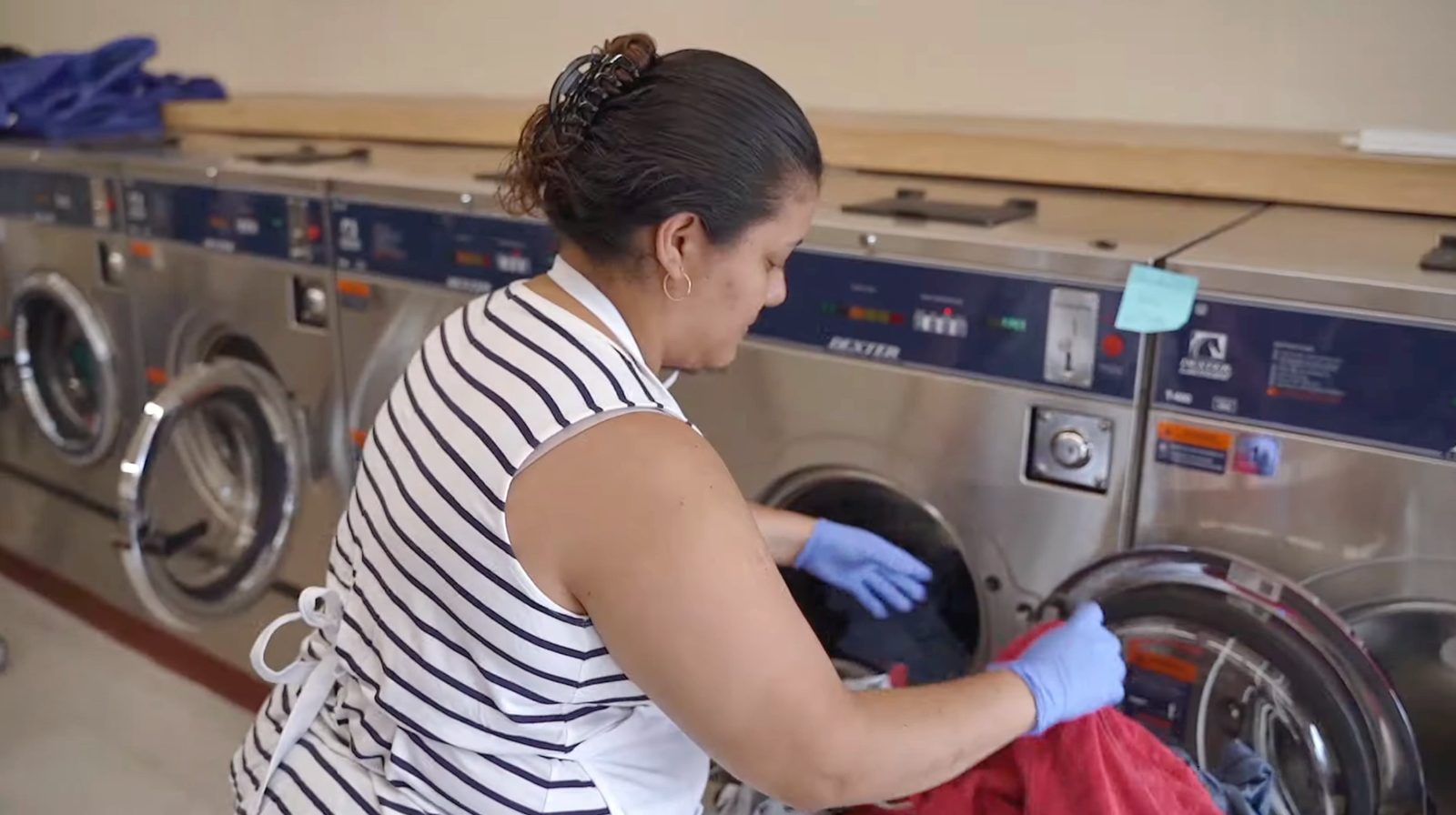 A team member loading laundry into a washer